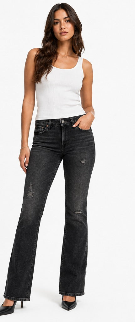 Model wearing Levi's 715 Bootcut faded black distressed – women's mid rise bootcut denim size 28